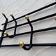 Iron and brass coat rack