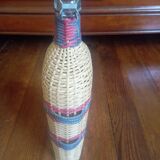 Glass and wicker bottle