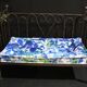 Wrought iron bed and bluish wool mattress