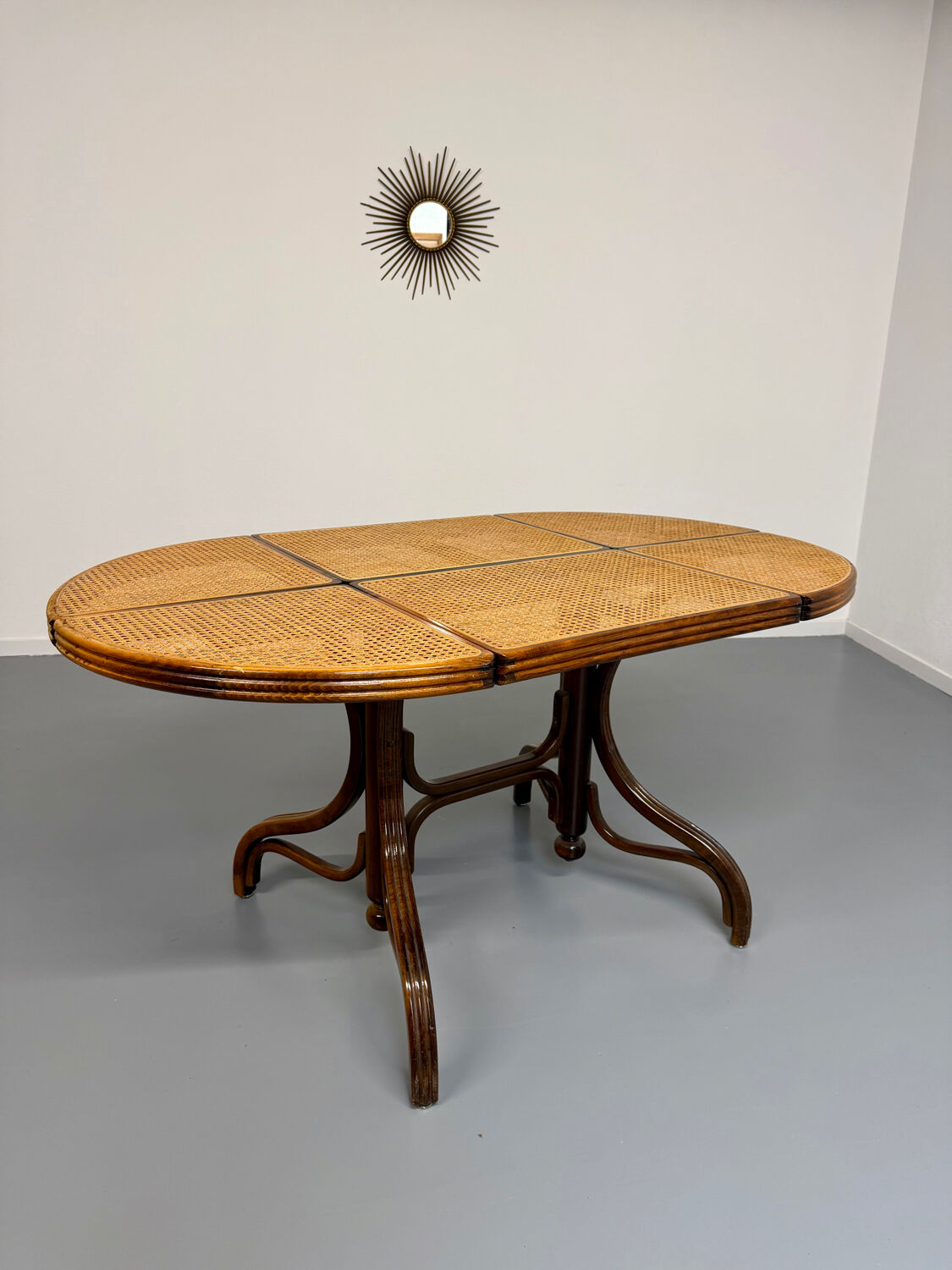Vintage dining table with a cane top by Mundus from the 1970s.