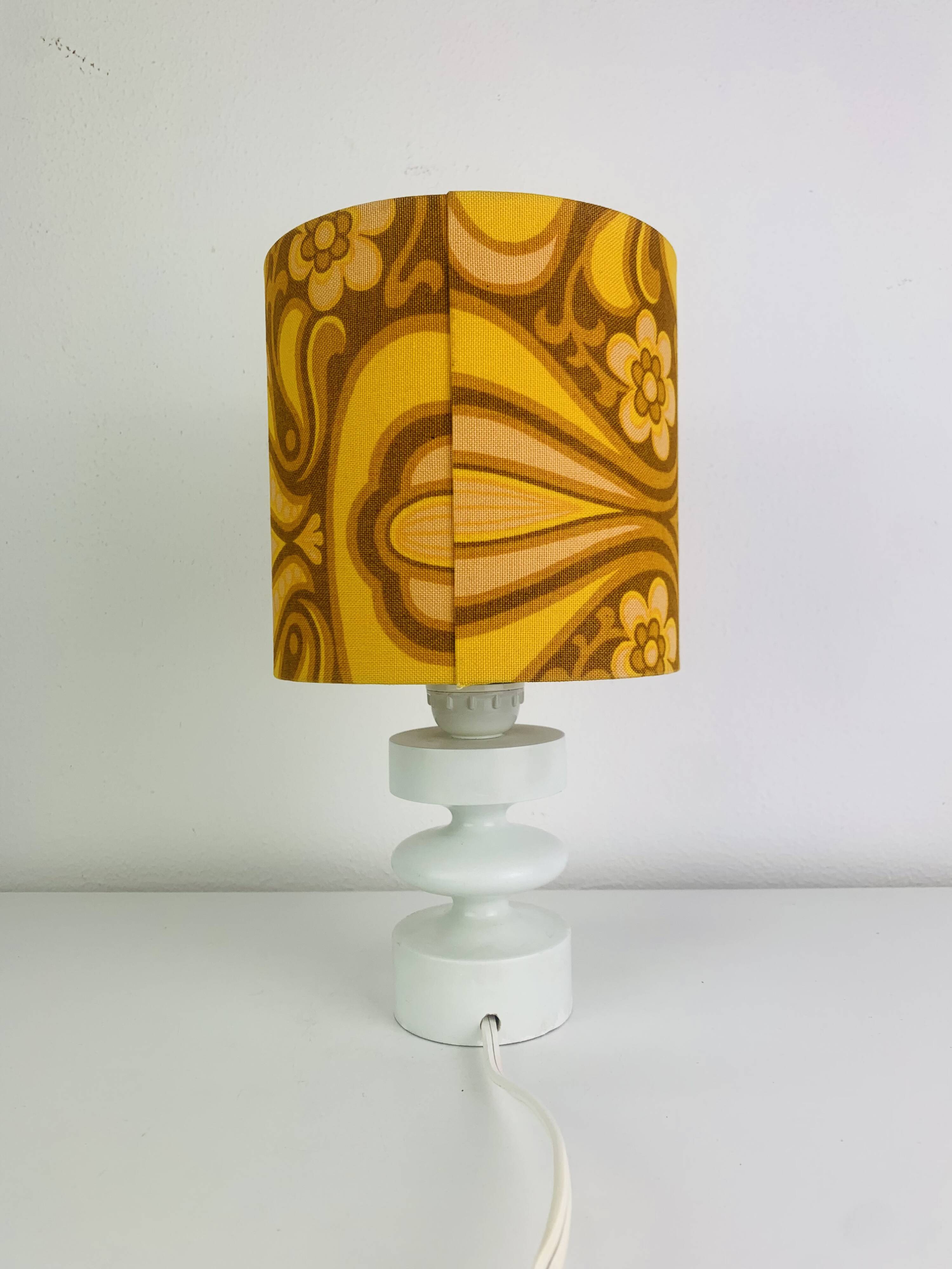 Temde lamp with turned wood and a seventies lampshade.