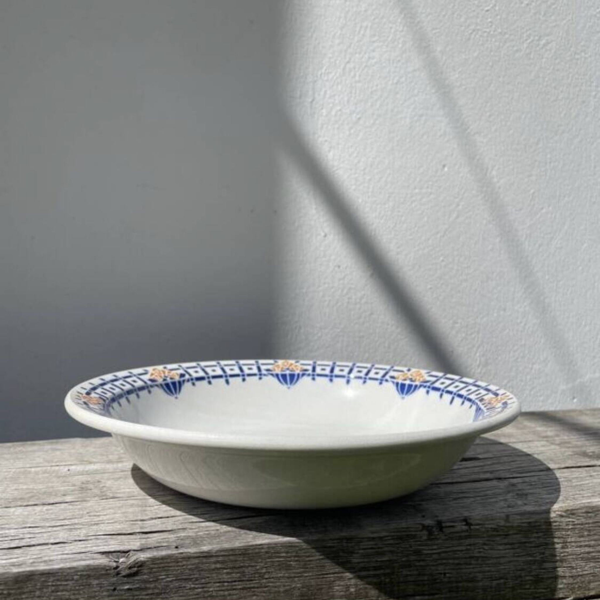Round, shallow ceramic salad bowl from Saint Amand