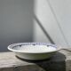 Round, shallow ceramic salad bowl from Saint Amand