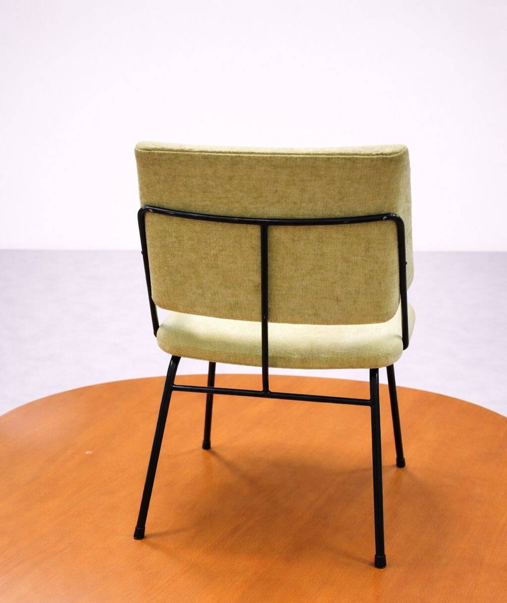Vintage 1950s chair in black metal and almond green fabric.