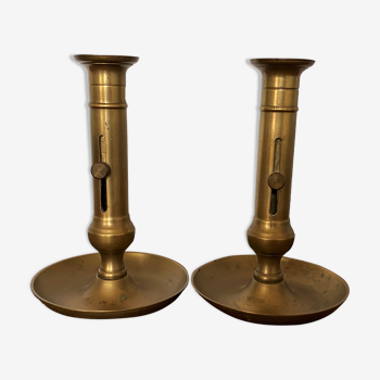 Pair of brass candle holders on push-bottomed