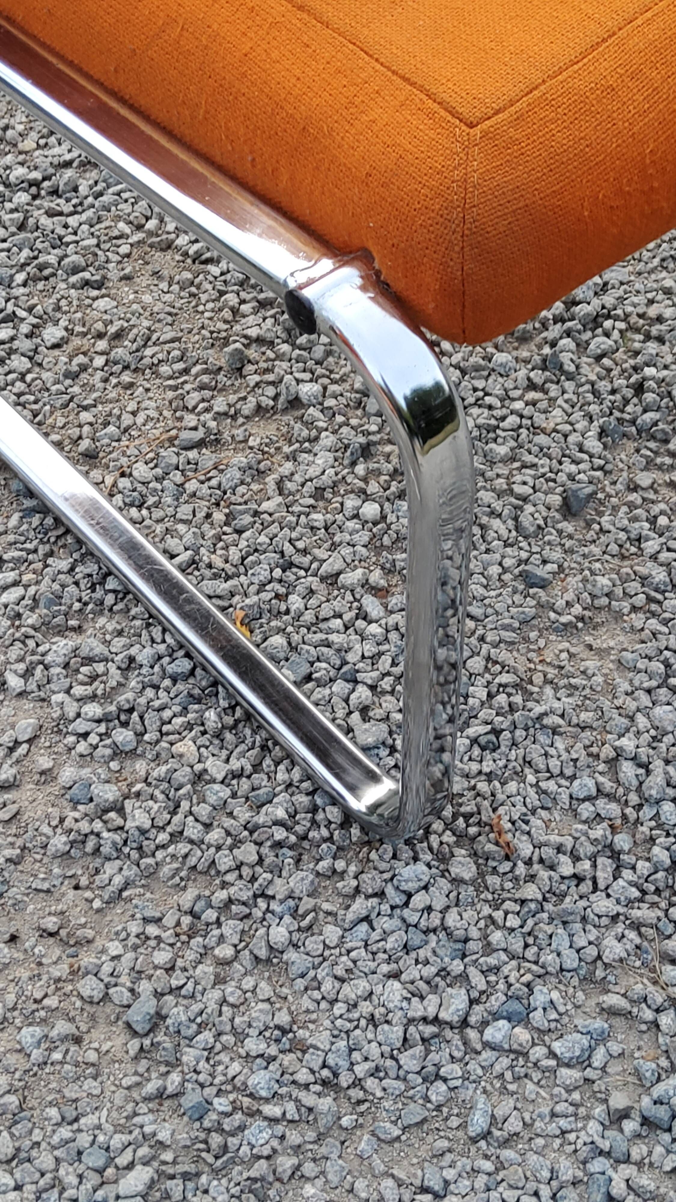 Pair of designer armchairs in orange fabrics and chrome tubes from the 70s