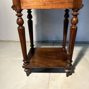Antique wooden bedside table with turned legs.
