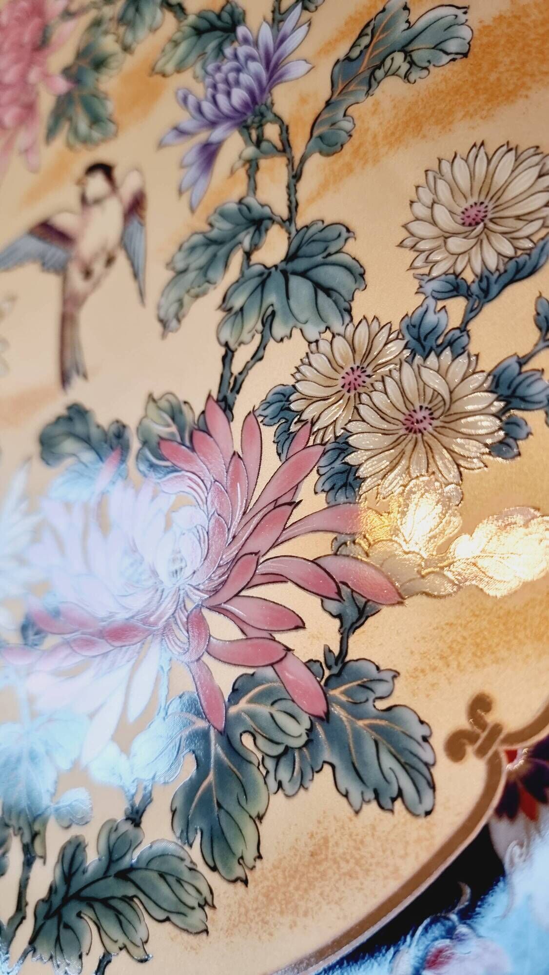 Vintage Japanese decorative plate with chrysanthemum and bird patterns.