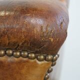Characteristic antique sheepskin leather armchair with beautiful details and a unique design