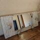 Wall-mounted coat rack with a patinated mirror