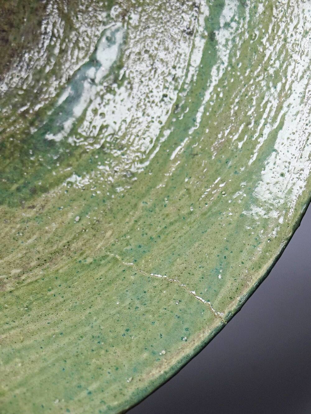 Wabi-Sabi handcrafted ceramic bowl in celadon green, 20th-19th century.