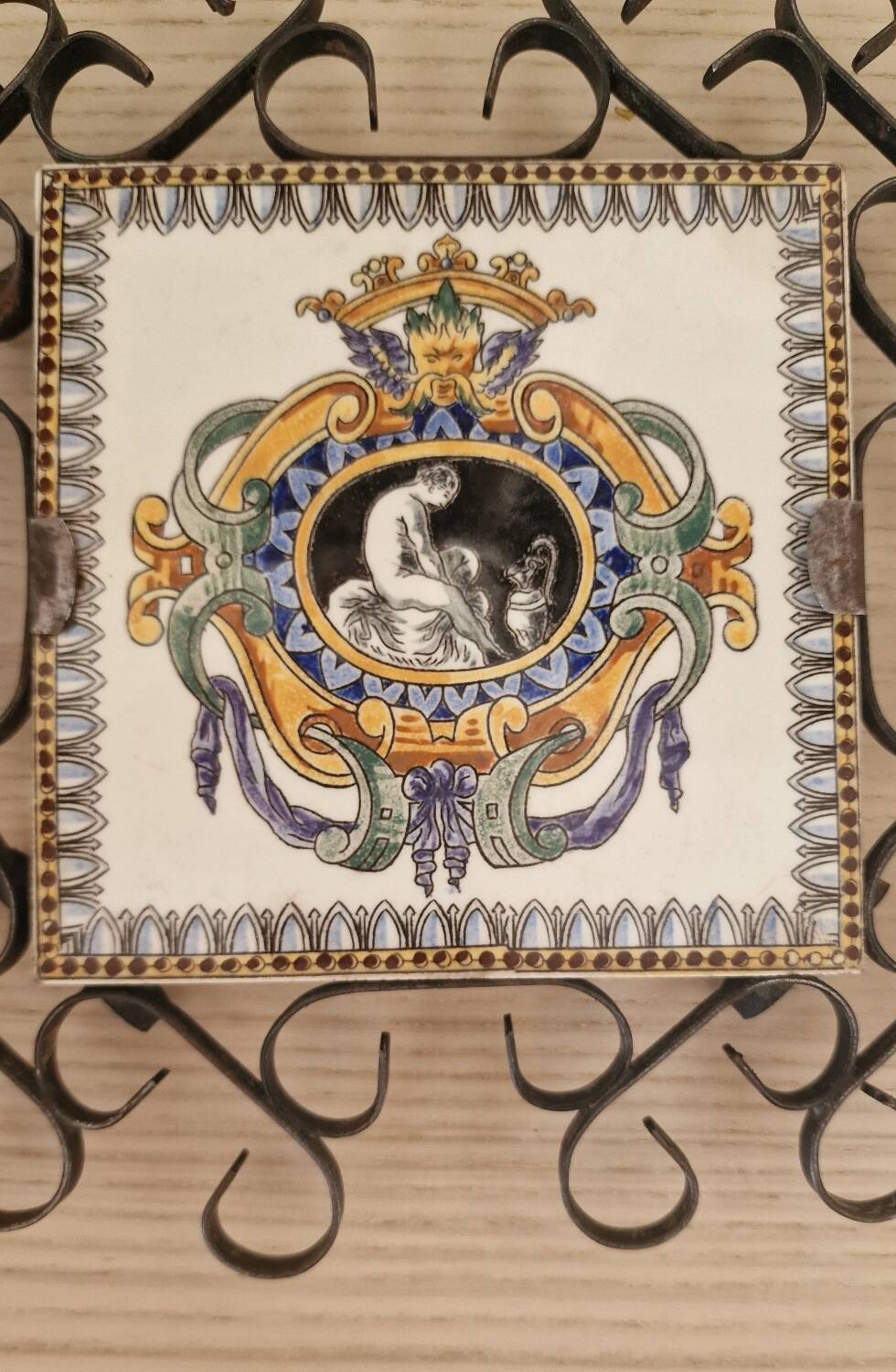 Hand painted gien tile on wrought iron trivet