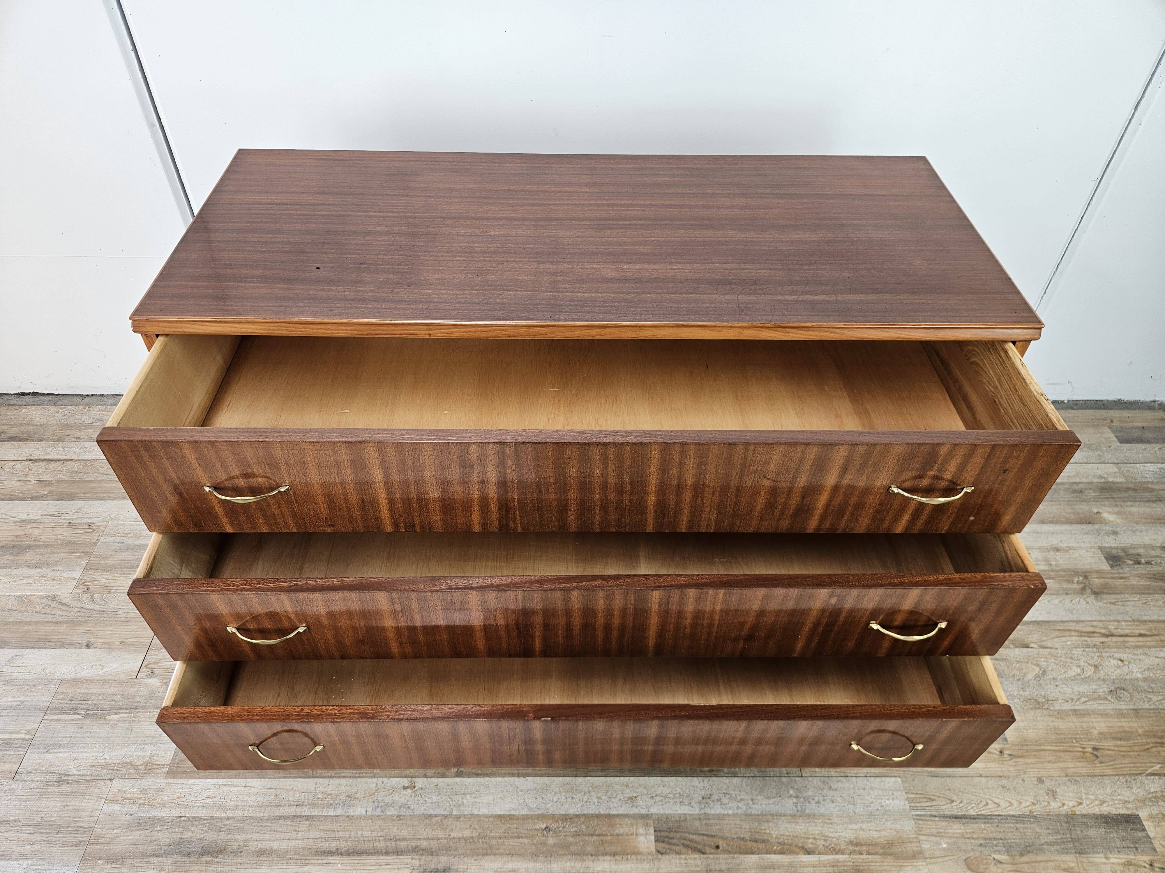 1950s chest of drawers covered in walnut with brass handles