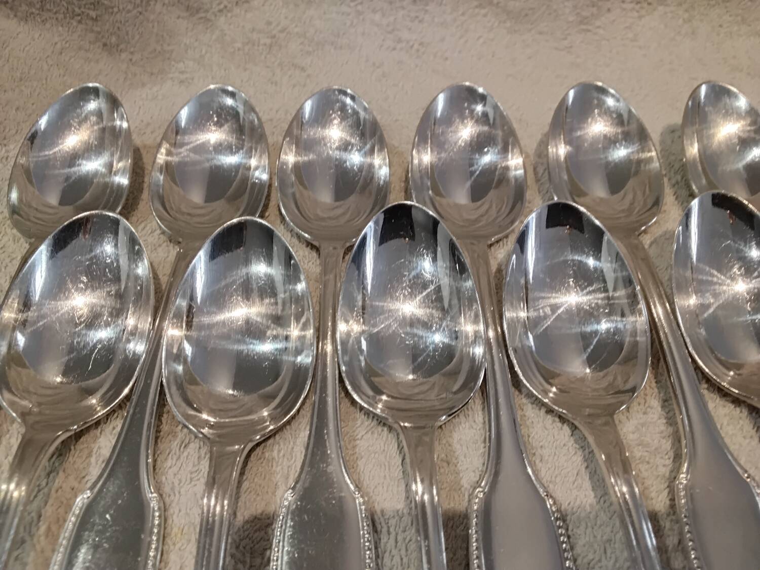 12 silver plated dessert spoons, goldsmith Alfenide, St LXVI pearls