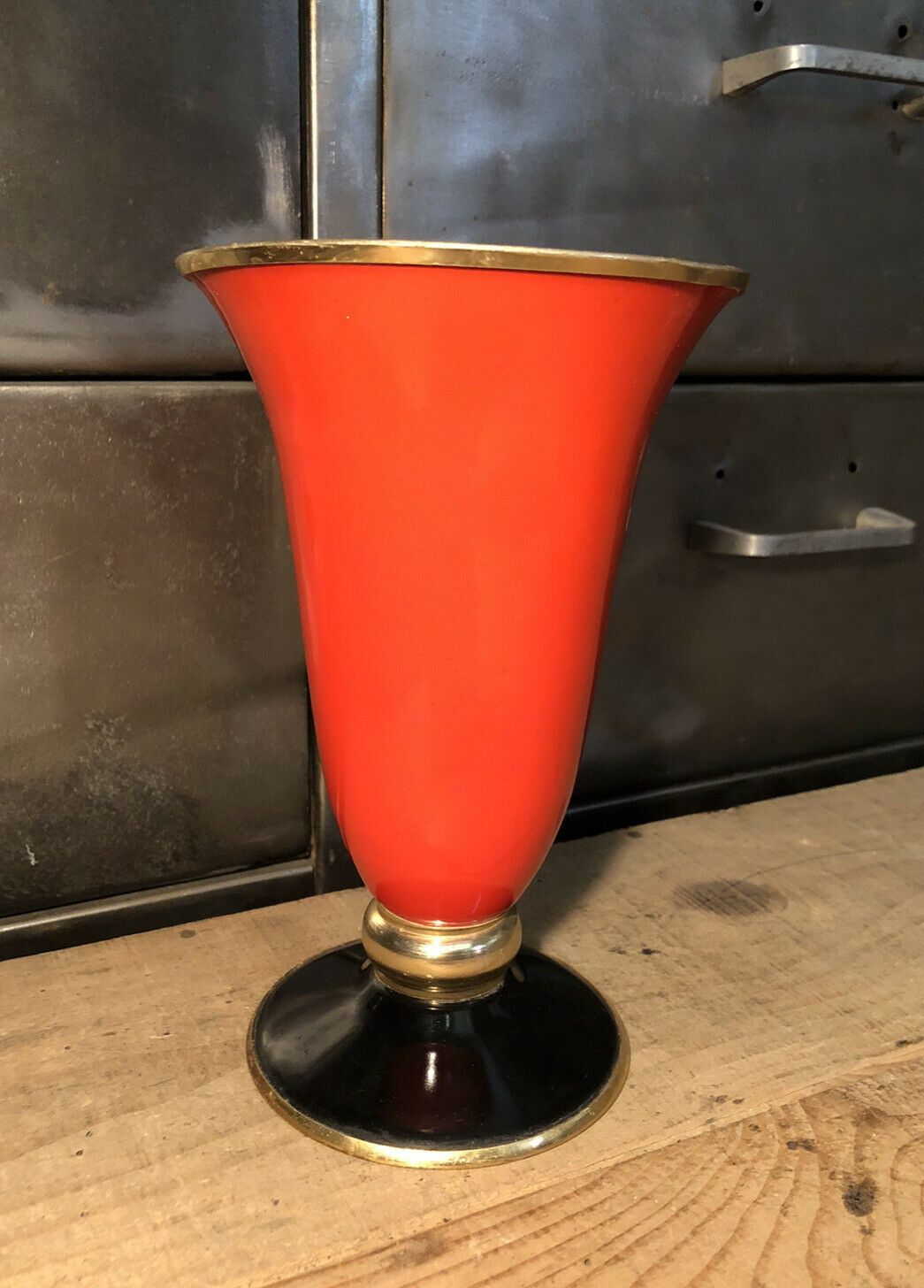 Cut vase on foot in red and black metal