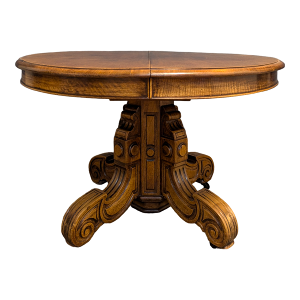 Guéridon, table extensible à pied central en noyer sculpté
