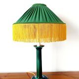 Green ceramic lamp with a vintage pleated fringe shade.