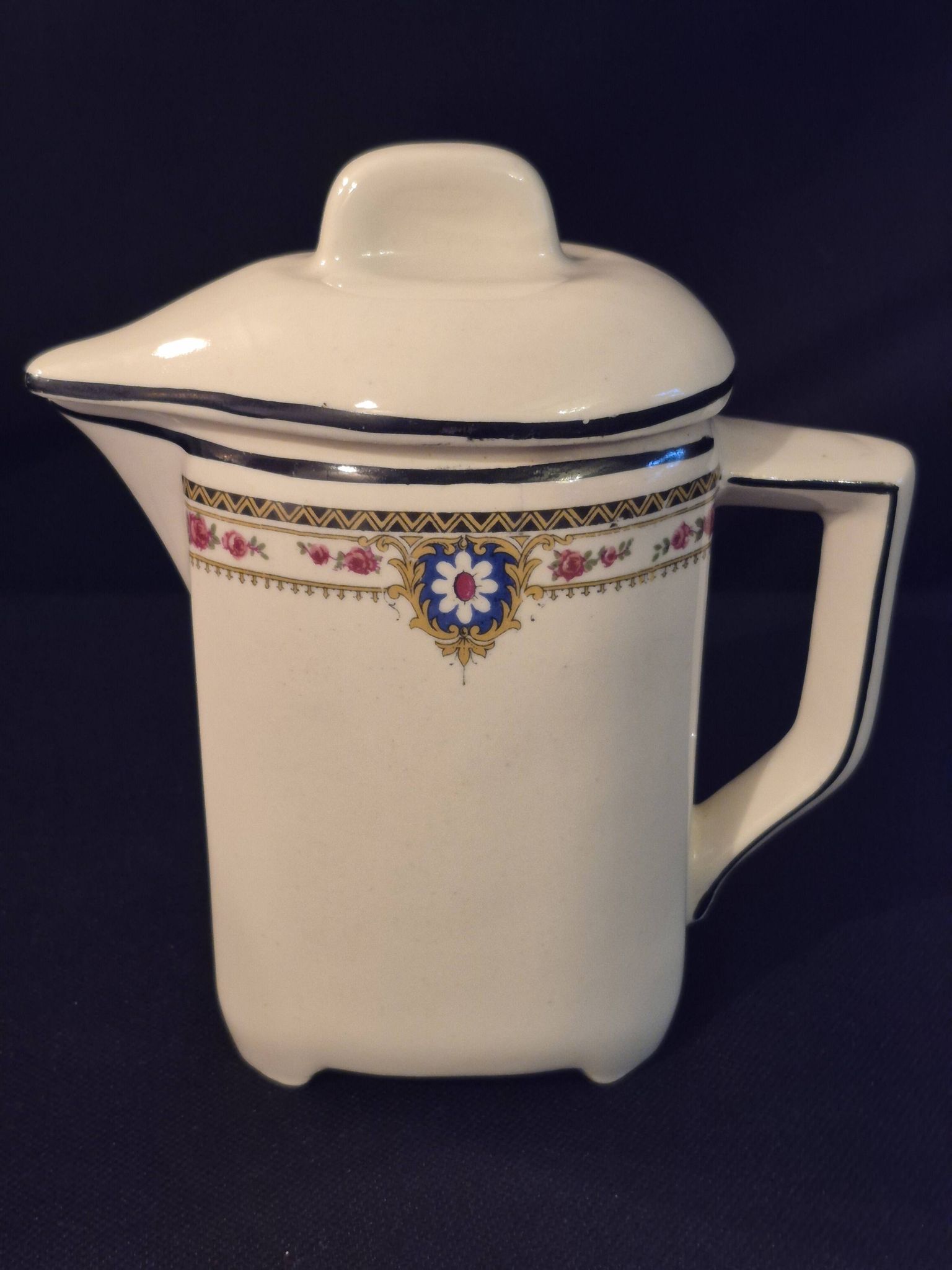 Vintage vase, geometric frieze and flowers with a black border.
