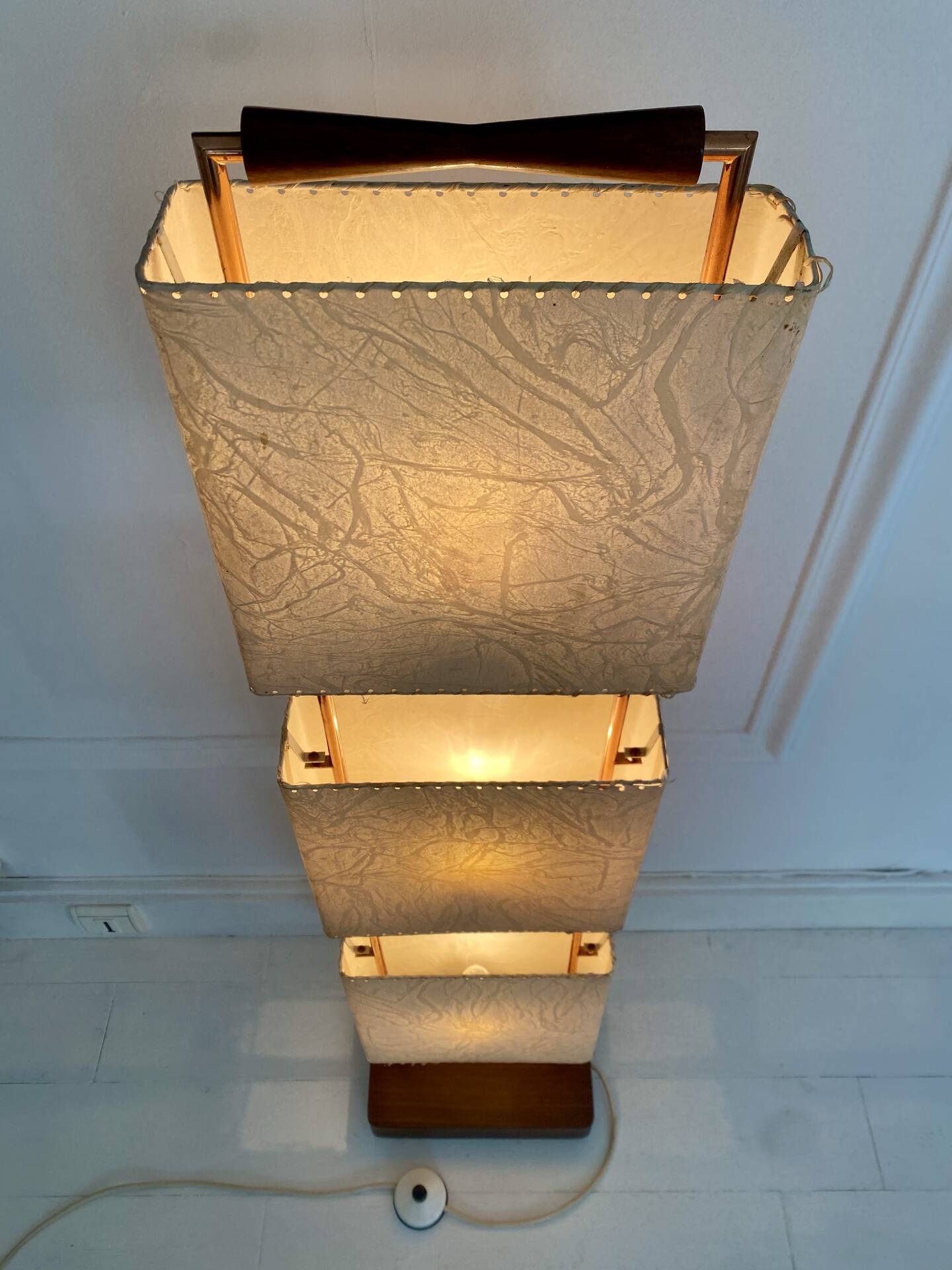 Wood and copper metal floor lamp with parchment.