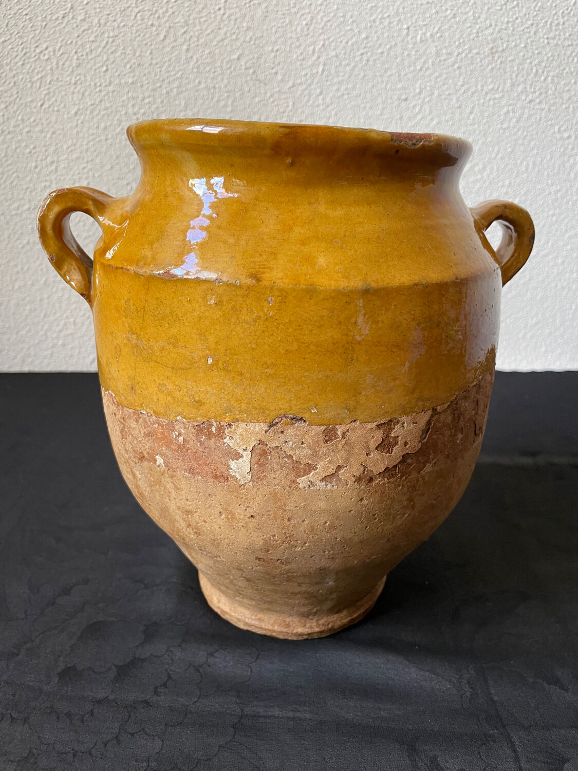 Old candied pot in yellow glazed terracotta