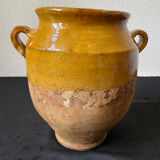 Old candied pot in yellow glazed terracotta
