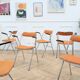 6 orange folding chairs