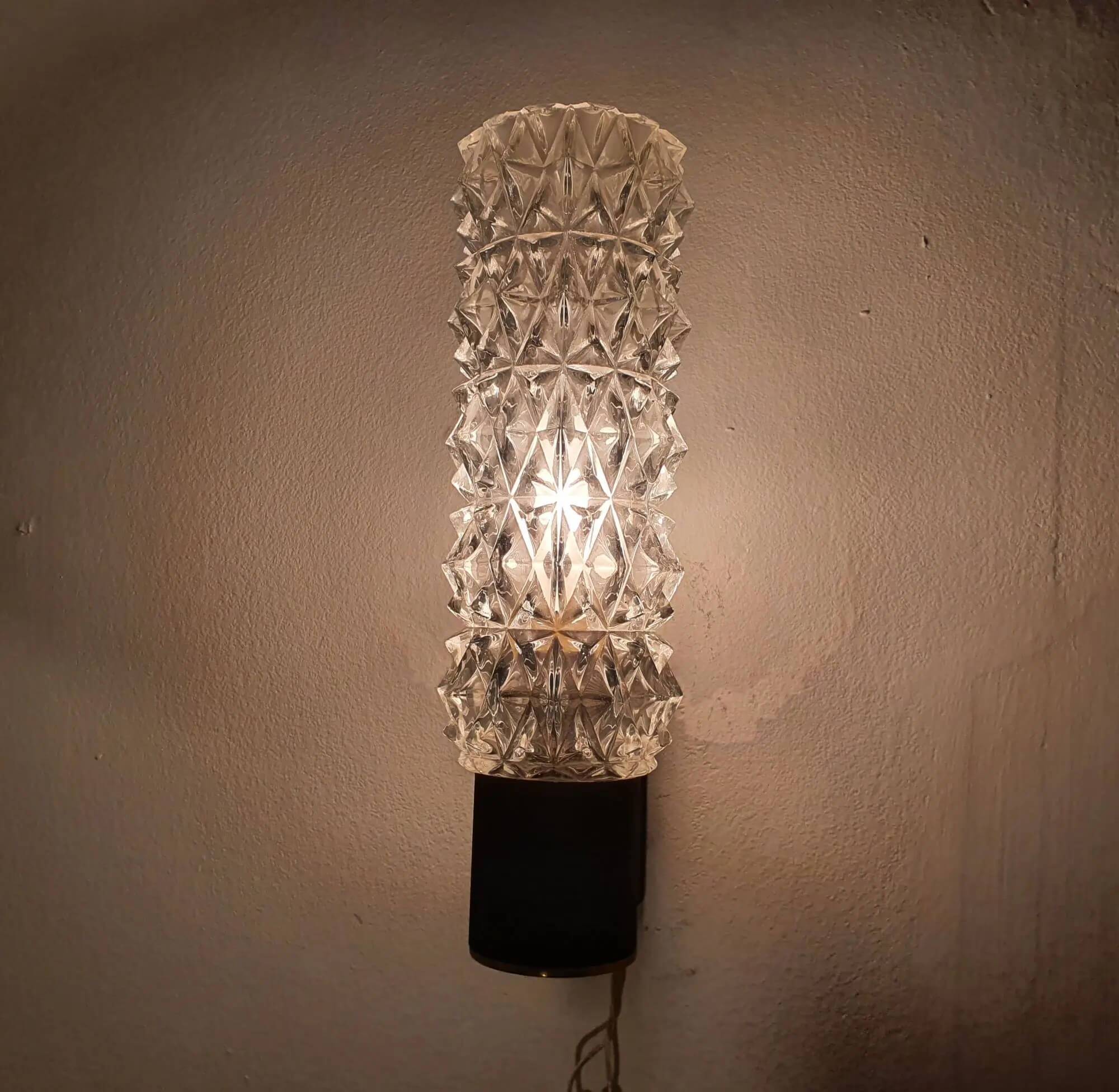 Black wall light with structured glass in Arlus style