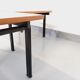 Suite of two vintage modernist Isa coffee tables in teak and black metal from the 60s