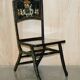 Pair of military folding chairs with Indian decoration.