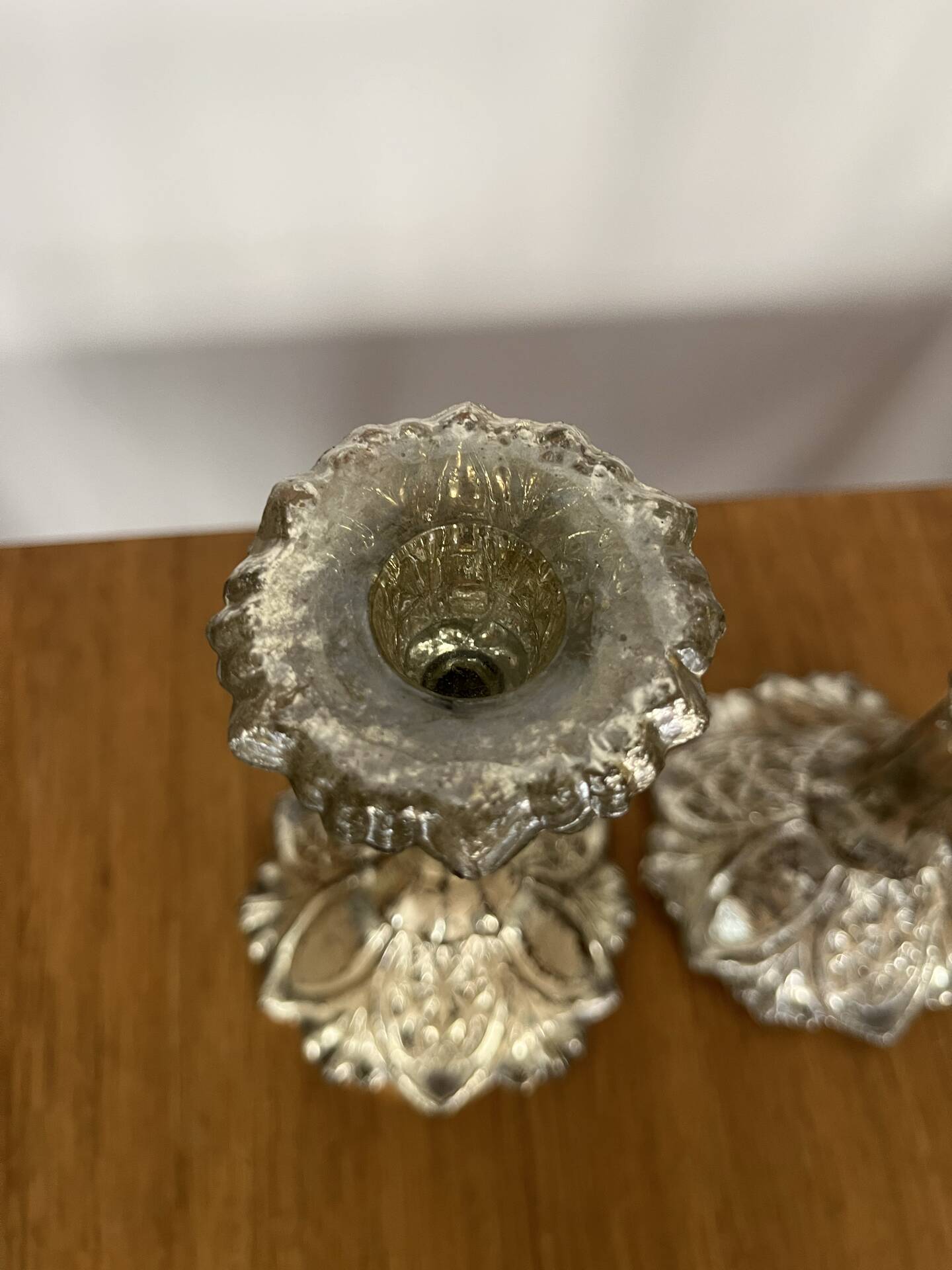 Pair of pressed glass candlesticks with silver plating.