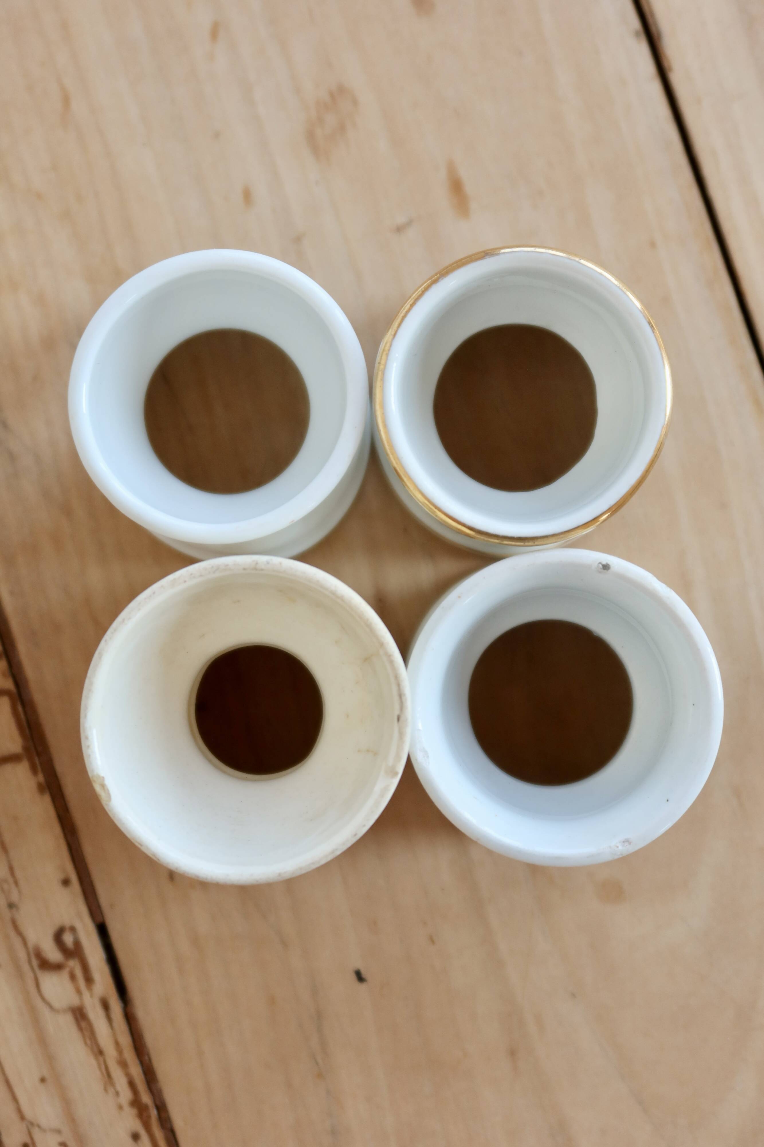 4 mismatched vintage diabolo egg cups in earthenware