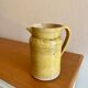 Old yellow glazed terracotta jug from southern France.