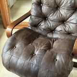 1970s Scandinavian armchair in curved laminated wood with a leather seat.