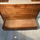 Antique carved wooden dressing table with marble and tilting oval mirror.