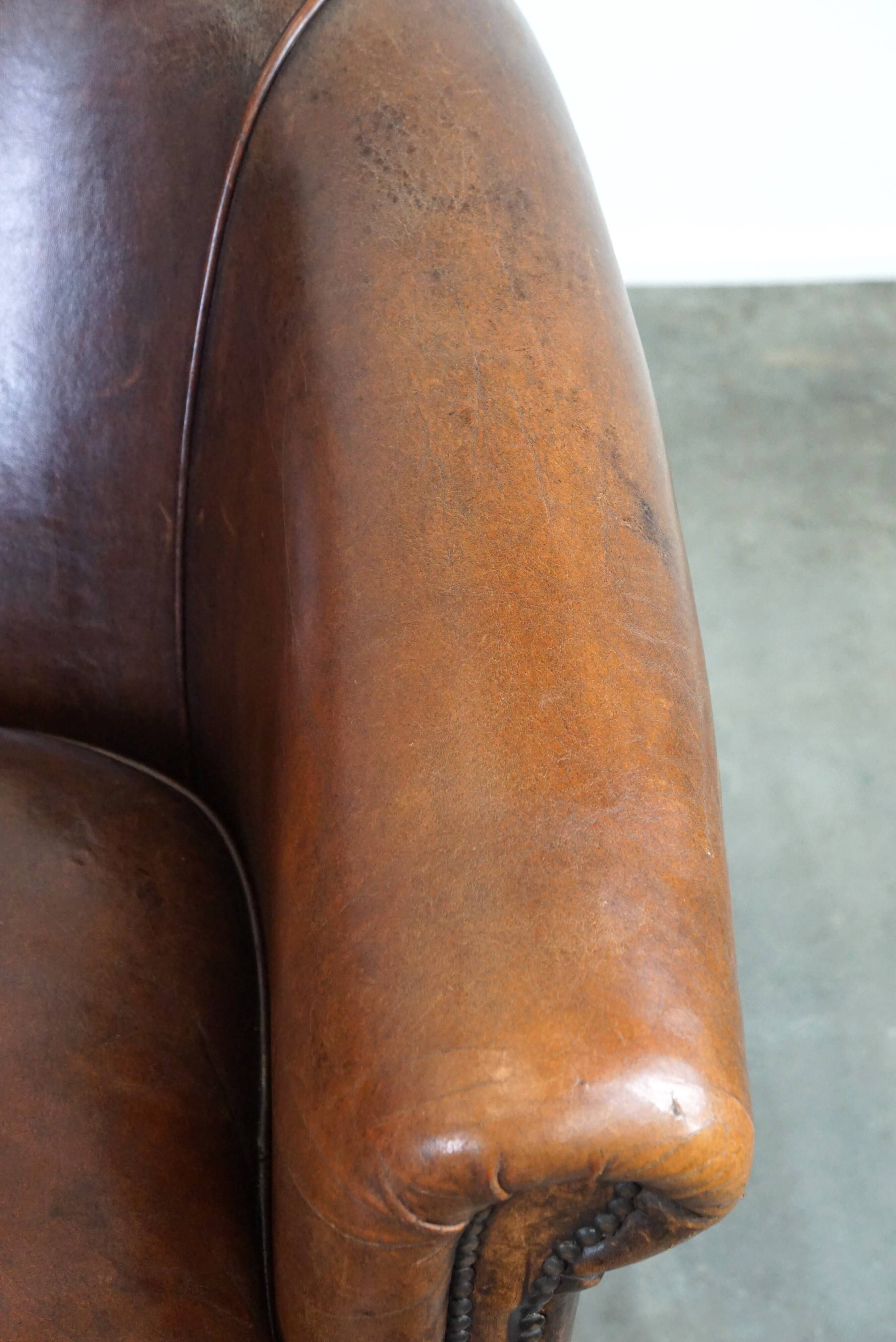 Set of two rugged sheep let of two rugged sheep leather club armchairs with a nice distressed look