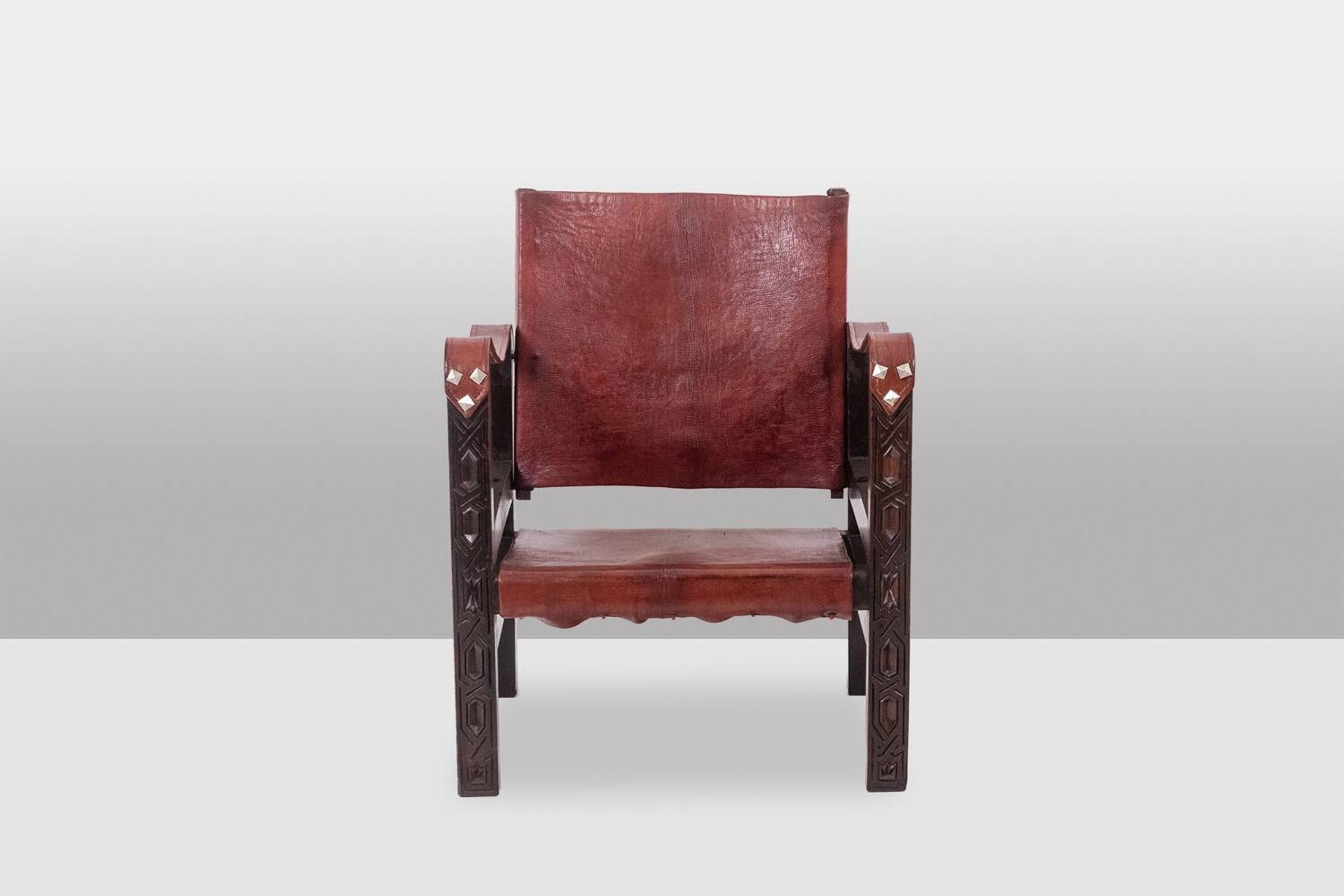 “Safari” armchair in wood and cognac leather. 1960s/70s.