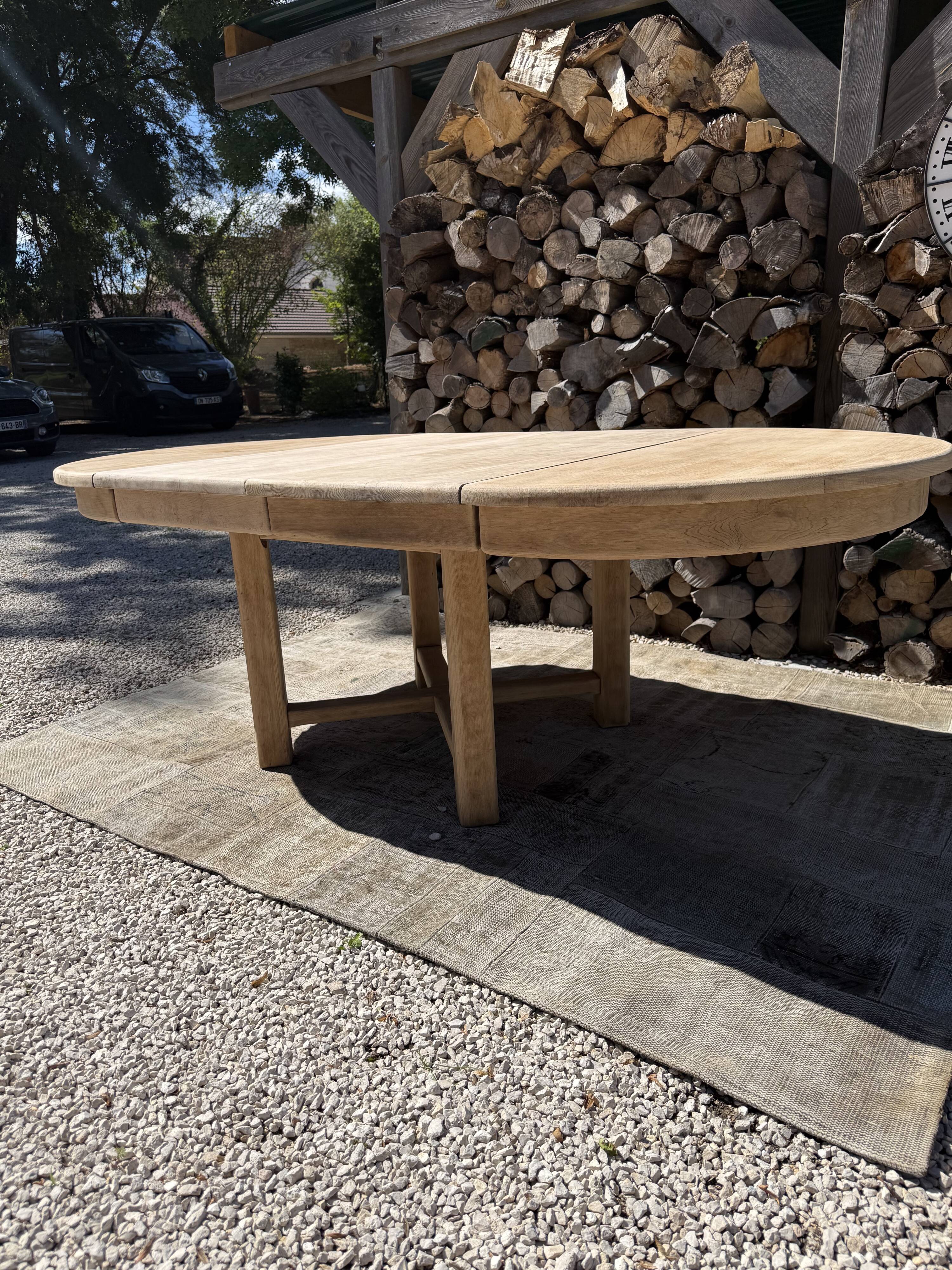 Round solid oak table with extensions, maximum 220cm.