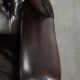 Dark brown cowhide Chesterfield wingback armchair in classic English style