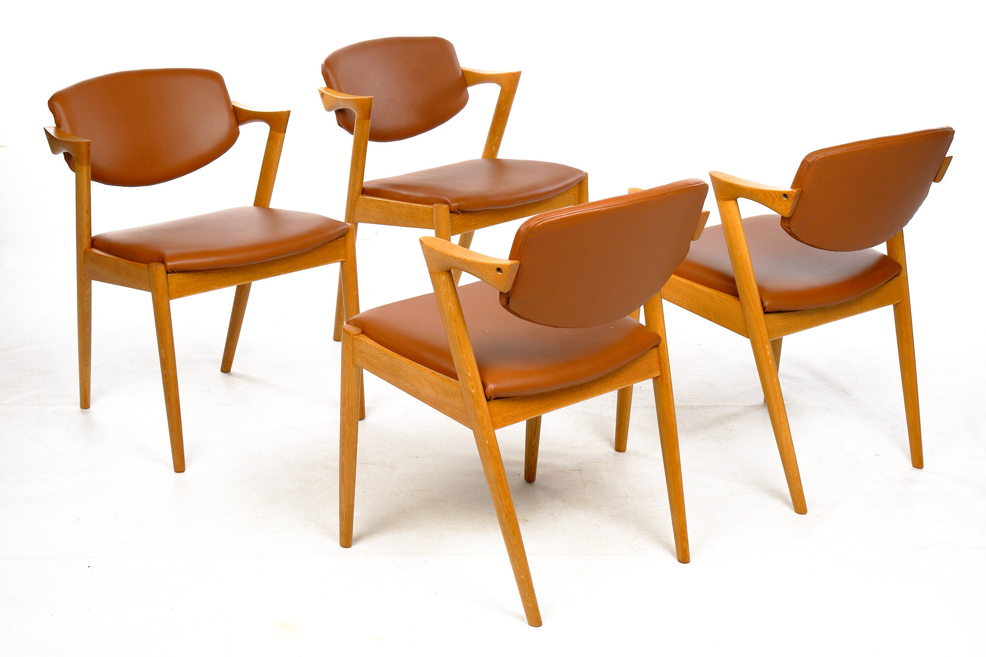 Four Kai Kristiansen oak chairs with new leather upholstery