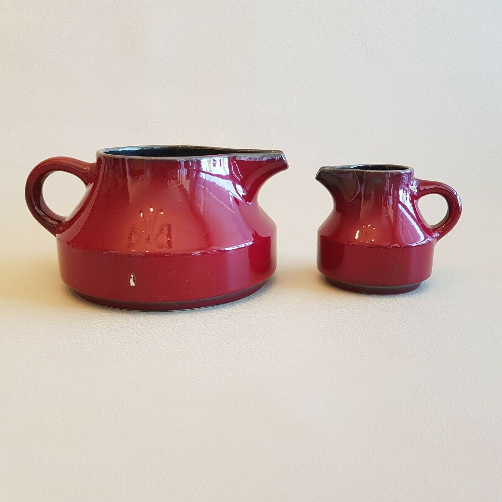 Teapot and milk jar in burgundy red ceramic