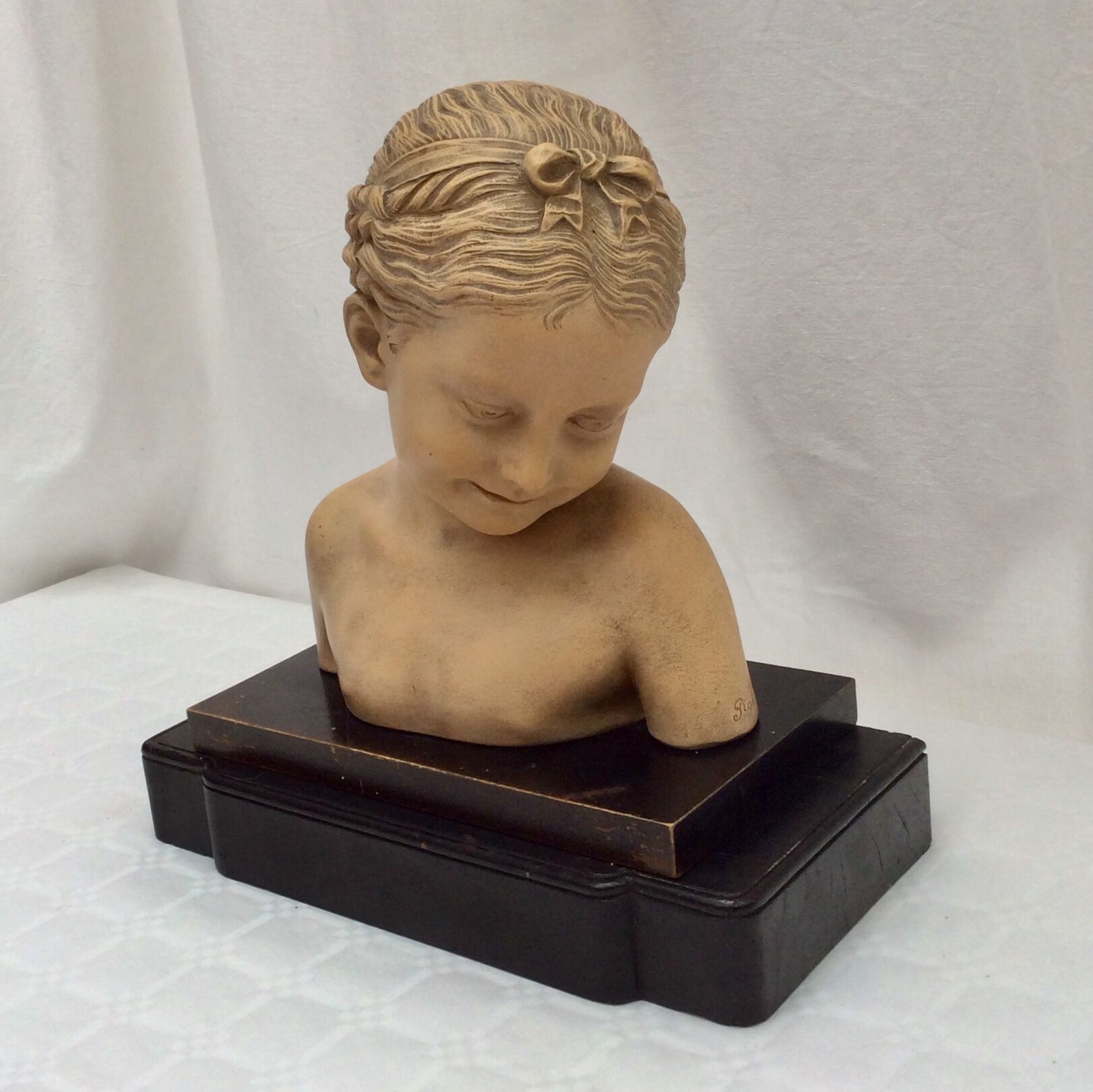 Girl's head in terracotta numbered