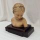 Girl's head in terracotta numbered