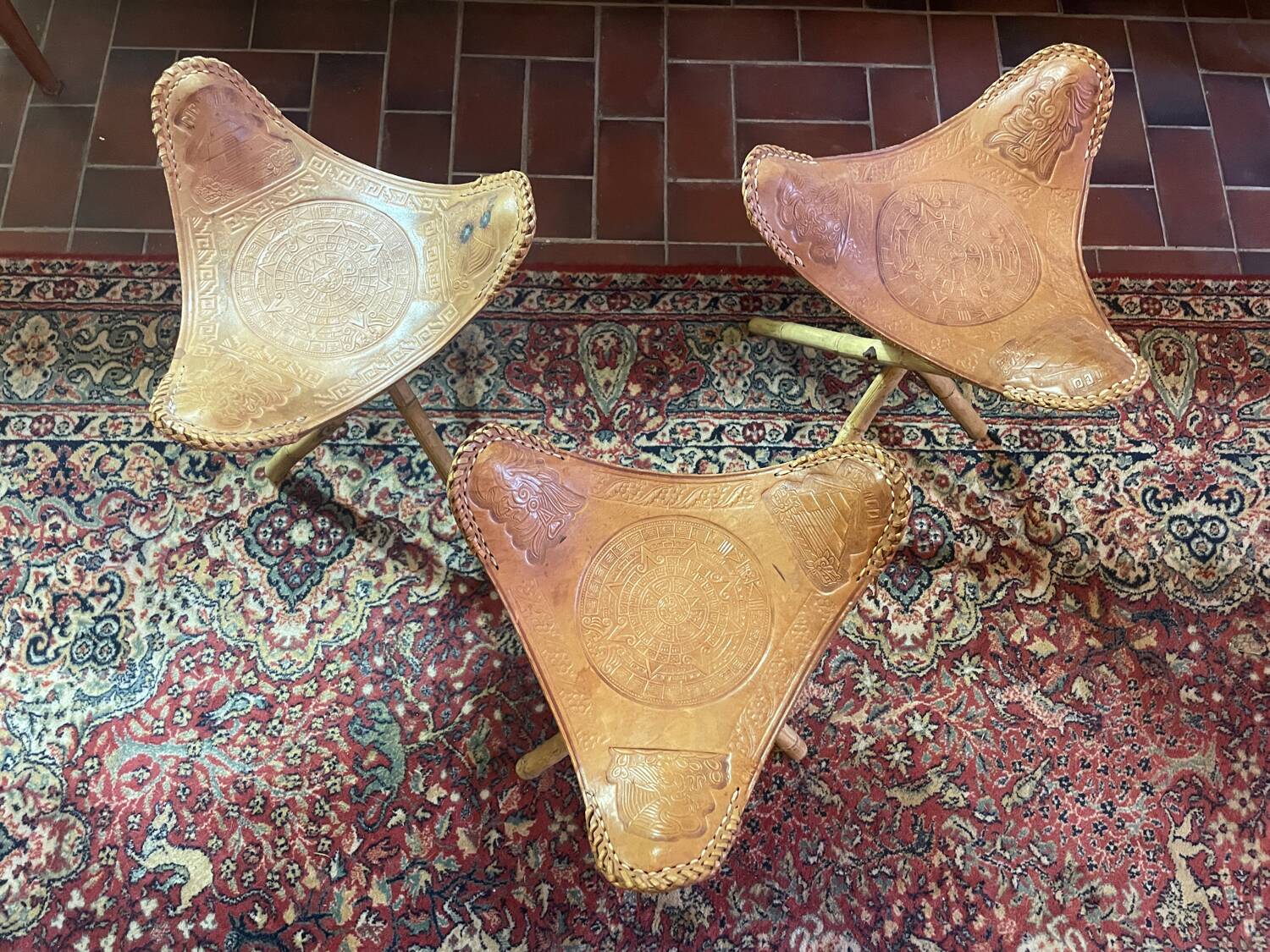 Vintage Mexican tripod stools in bamboo and leather.
