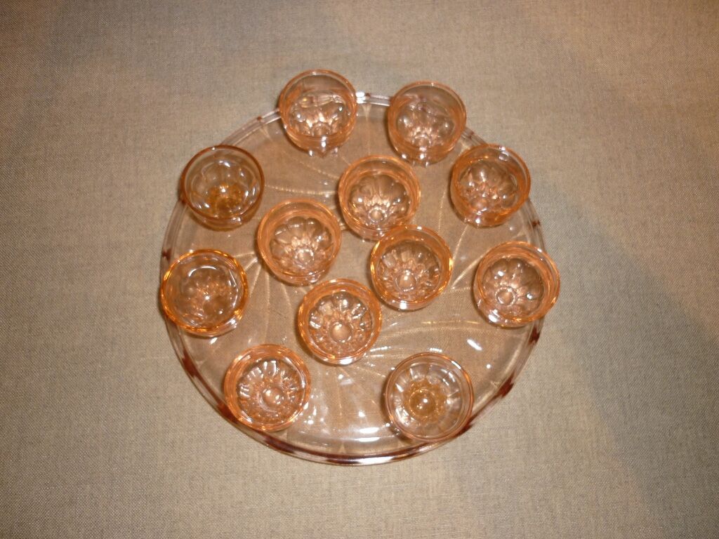 12 shot glasses on pink glass tray