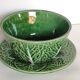 Two bowls in dabbling and their plates leaves cabbage