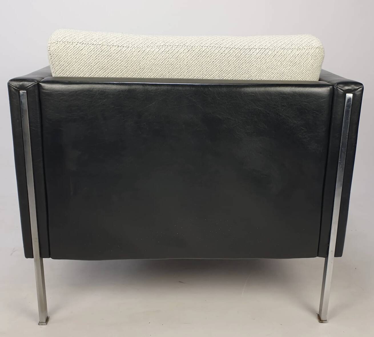Pair of armchairs by Pierre Paulin for Artifort, black leather and cream fabric.