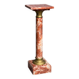 Marble pedestal decorated with gilded brass.