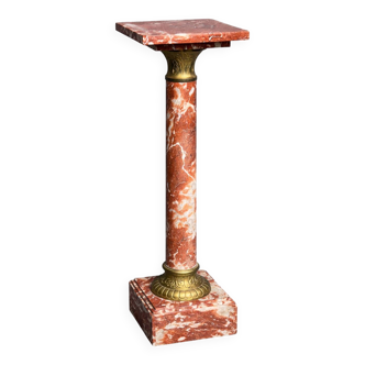 Marble pedestal decorated with gilded brass.