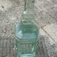 Square bottle of molded-pressed glass with faucet
