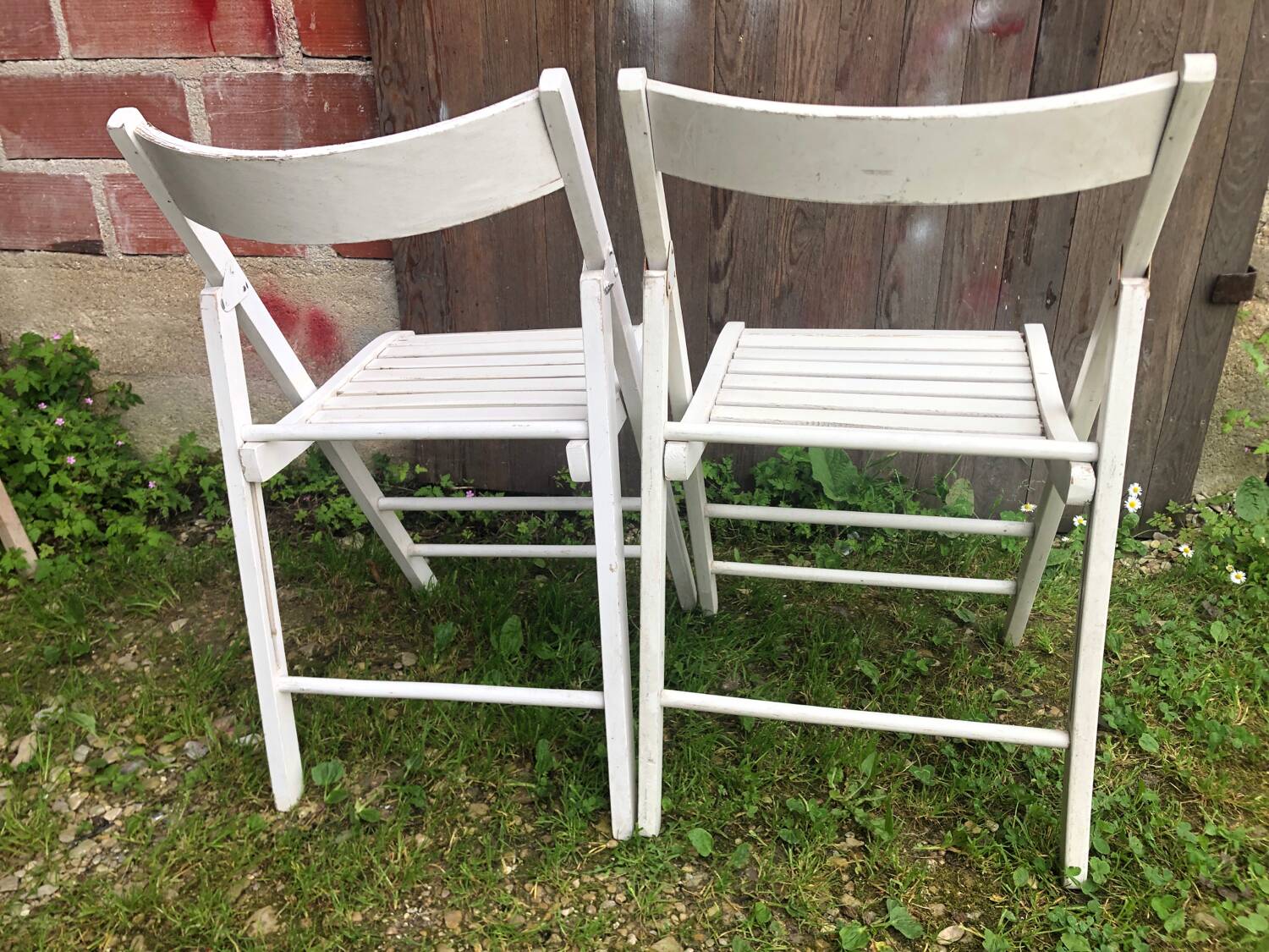 Pair of vintage white wooden folding chairs